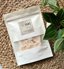 Load image into Gallery viewer, White sealed package with clear window showing heart shaped Wax Melts in the Taos Sage Scent, sitting on a woven mat.
