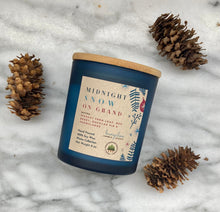 Load image into Gallery viewer, Bungalow&#39;s Midnight Snow on Grand Holiday Candle in frosted blue jar with wooden lid.
