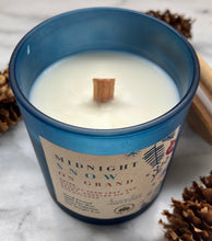 Load image into Gallery viewer, The wood wick on Bungalow&#39;s Midnight Snow on Grand Holiday Candle in a frosted blue jar.
