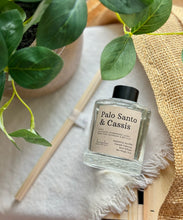 Load image into Gallery viewer, The Palo Santo &amp; Cassis scent in a reed diffuser from the Cascade Collection.
