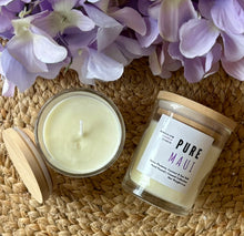 Load image into Gallery viewer, Two candles in glass jars with wooden lids sit on a woven surface with purple flowers-they're labeled with the scent of Pure Maui.
