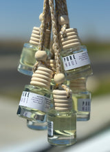 Load image into Gallery viewer, The Pure Maui scent is shown in a group of car diffusers from the Coastal Collection
