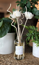 Load image into Gallery viewer, The Santal &amp; Rum Scent in a reed diffuser from the Classic Collection shown with floral wood reeds.
