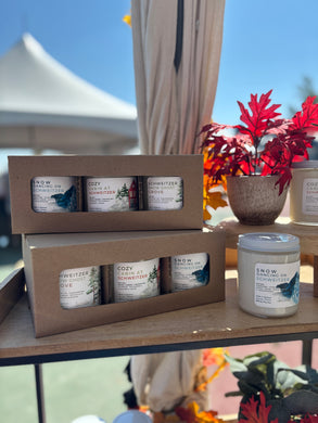 Set of 3 Schweitzer candles in a gift box with decorative elements on a table.
