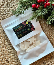 Load image into Gallery viewer, A white pouch of soy wax melts in the Snow Country Coeur d'alene scent laying flat on a woven mat.
