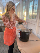 Load image into Gallery viewer, Woman pouring wax during a candle making class.
