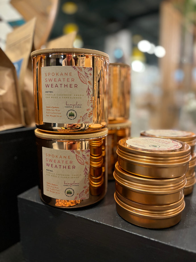 The Signature Spokane Sweater Weather in Rose Gold jars and tins is shown stacked together in the large 16oz jar and smaller travel tins.