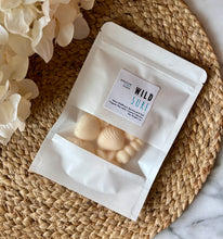 Load image into Gallery viewer, Sea shell shaped wax melts from the Coastal Collection in a resealable package. Wild Surf scent shown. 

