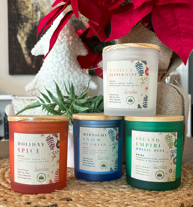 4 Holiday Scented Candles in colorful frosted jars.