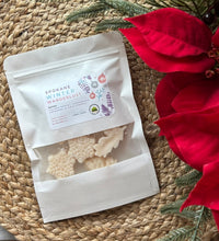 Load image into Gallery viewer, A white pouch of soy wax melts in the Spokane Winter Wanderlust scent laying flat on a woven mat.
