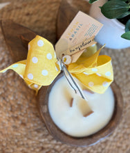 Load image into Gallery viewer, Dark wood stained dough bowl candle in the shape of a bunny with yellow ribbon and 'Lemon &amp; Basil' tag on a woven surface
