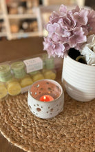 Load image into Gallery viewer, A Bungalow tealight being burned in a white ceramic tealight holder.

