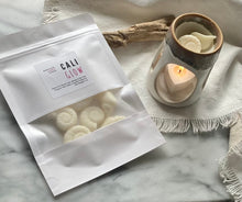 Load image into Gallery viewer, Sea shell shaped wax melts from the Coastal Collection in a resealable package. Cali Glow scent shown. 
