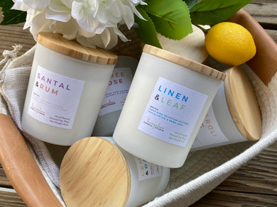 Group of candles from the Classic Candle Collection, stacked in a basket.