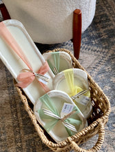 Load image into Gallery viewer, A group of the coastal dough bowl candles wrapped in ribbon in a basket
