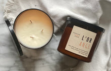Load image into Gallery viewer, The L&#39;Orange candle scent from the Kitchen Collection, shown in large 16 oz sized amber-colored glass jar with 3 wicks.
