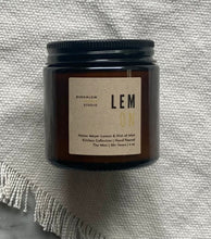 Load image into Gallery viewer, The Lemon candle scent from the Kitchen Collection, shown in mini 4 oz sized amber-colored glass jar.
