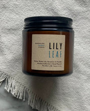 Load image into Gallery viewer, The Lily Leaf candle scent from the Kitchen Collection, shown in mini 4 oz sized amber-colored glass jar.
