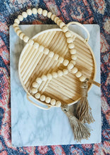 Load image into Gallery viewer, Natural Mango Wood Contentment Bead with Jute Tassels draped in basket for home decor
