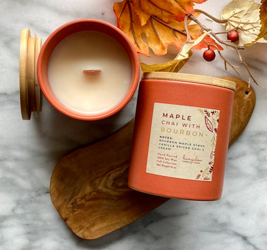 The Maple Chai with Bourbon scent from the Fall Candle Collection is shown in a beautiful rust-colored ceramic jar.