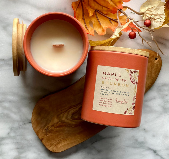 The Maple Chai with Bourbon scent from the Fall Candle Collection is shown in a beautiful rust-colored ceramic jar.