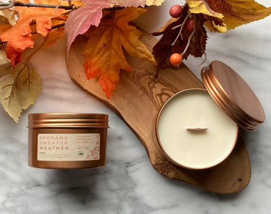 The Spokane Sweater Weather scent shown in the signature rose gold travel tin.