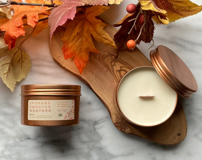 The Spokane Sweater Weather scent shown in the signature rose gold travel tin.