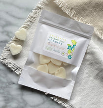 Load image into Gallery viewer, Heart-shaped Soy Wax Melts from the Bungalow Spring and Summer Collection in a white sealed package with a window in the Spokanite Greenhouse Goddess scent.
