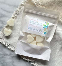 Load image into Gallery viewer, Heart-shaped Soy Wax Melts from the Bungalow Spring and Summer Collection in a white sealed package with a window in the Urban Equinox @ Kendall Yards scent.

